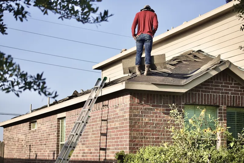 Professional roofer working on a residential roof in Belmont Park